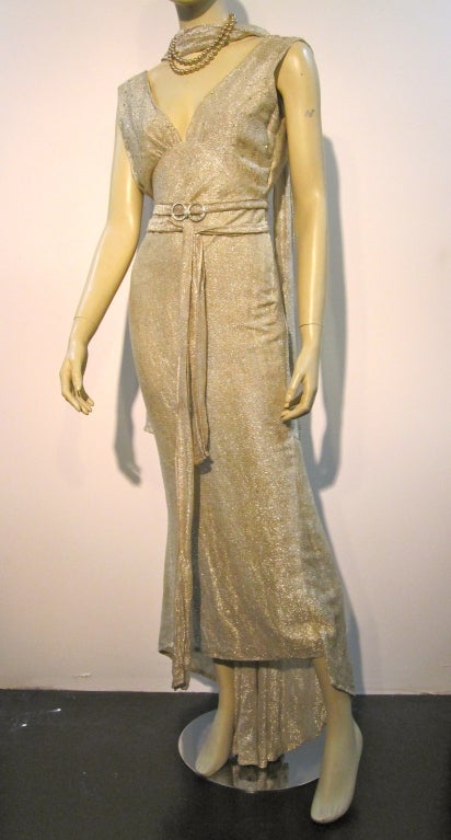 A wonderful 30s lamé bias cut gown with deep plunging back v-neckline.  Bodice is studded with prong-set rhinestones and a matching foulard and belt with original rhinestone buckle is included.