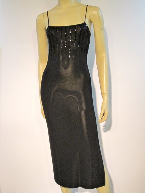 A sexy, slinky Thierry Mugler rayon knit dress with spaghetti straps high side slit and black sequin embellishment.  Marked size Medium.