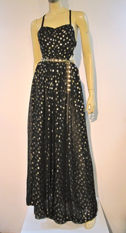 A daring 70s disco dress made of silk chiffon with gold lamé  polka-dots. Elastic waist, deep cut back and sides with lace-up back and side straps,m and full gathered skirt. Approx. size 4.