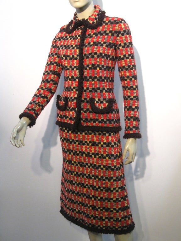 A gorgeous 70s Adolfo knit skirt suit reminiscent of 1930s Chanel designs.  In red, gold, and chocolate brown textured knit.  Originally sold at Neiman-Marcus. Size 6