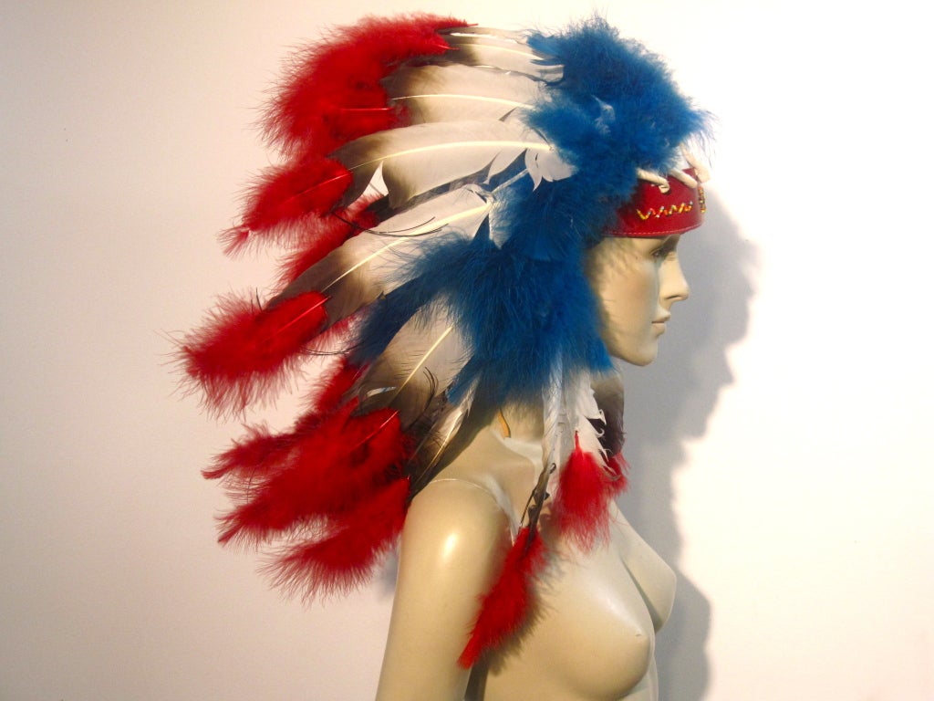 A 1950s souvenir feather headress made by the Cherokee Tribe on the Qualla Reservation.  In fantastic condition with vibrant colors!