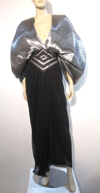 1970s Wayne Clark accordion pleated bat-wing silver lamé and black disco gown with open back and cummerbund belt included.  Canadian size 4, US size 2