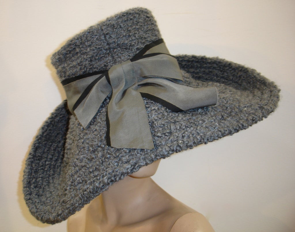 A fantastic and dramatic 1960s Mr. John wide brimmed trapunto stitched hat with two tone grosgrain ribbon trim and monogram fabric lining.  Originally sold at the French Room at Marshall Field and Co.  Measures 21