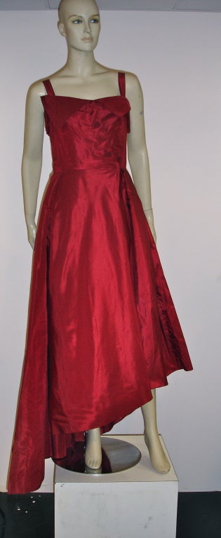 Antonio Cánovas del Castillo Haute Couture. 
In the infamous Red coveted by Elizabeth Arden.