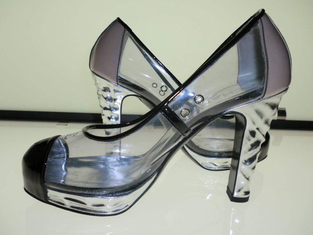 Fabulous Chanel size 37 Chanel vinyl and chrome cap-toe spectator pumps in clear vinyl, textured chrome platforms and heels, nude-tone patent leather structured heel and black patent leather rounded toe cap.  Small 
