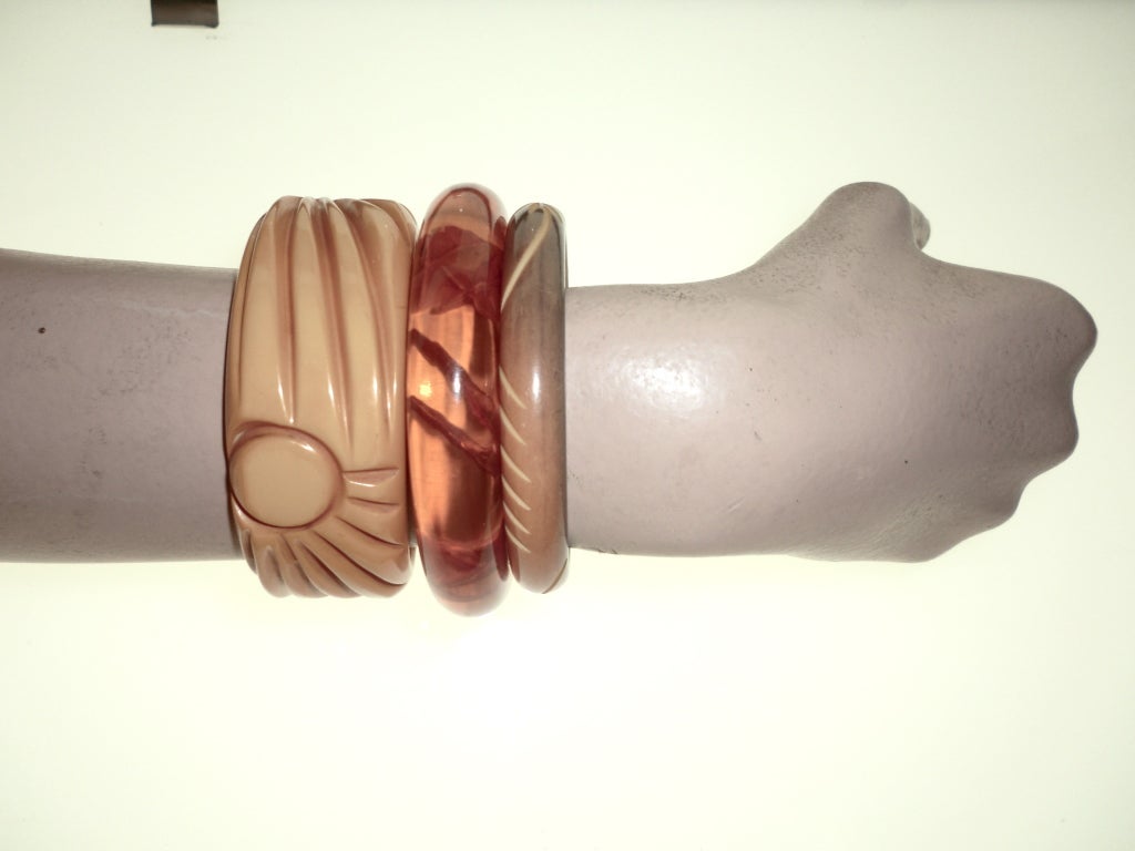A trio of carved Bakelite and Lucite bangles in butterscotch, apple juice and olive color.  All size medium.