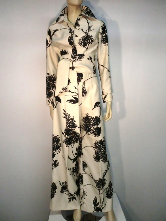 A fantastic and sexy Tori Richard 70s black/white floral print pantsuit from Honolulu with wide leg pants and cropped button-down jacket and attached sash belt.  Size 8.