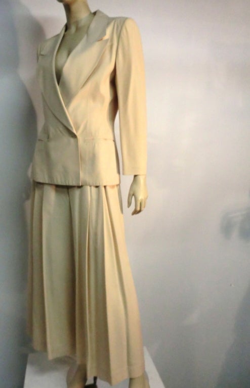 A wonderful Claude Montana 80s pantsuit with vented-back jacket, fitted yolked pants and wide pleated palazzo legs in a lovely ecru color.  French size 42, US size 8.