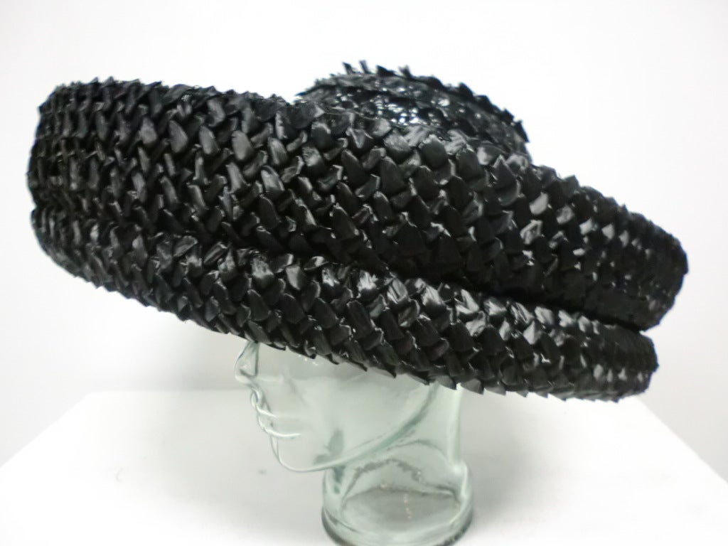 A gorgeous and bold 60s black woven straw hat with wide upturned brim grosgrain band and inner lining.  Originally sold at Marshall Field and Company.  

Size M-L