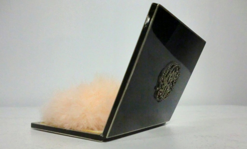 A gorgeous 1920s Deco styled enamel powder compact for loose powder the jeweled monogram crest and original marabou feather puff.