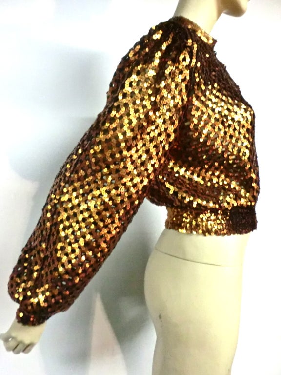 A super sassy 70s I. Magnin bronze sequin mesh button up sweater with cinched cuffs and waistband. Size M.