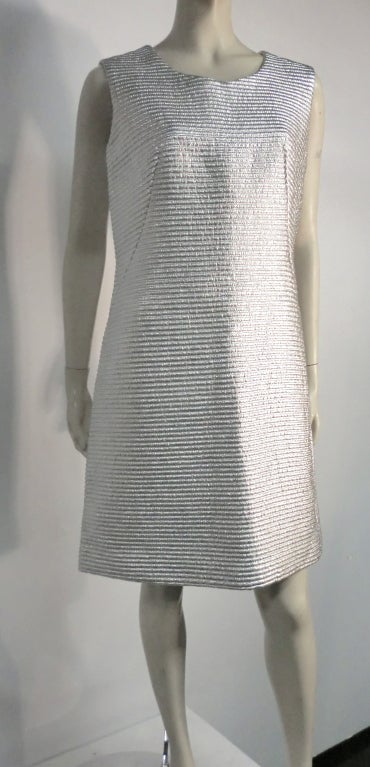 A fabulous 1960s silver lamé cocktail dress, cut in an a-line style and zipping down the back.   Size 6-8