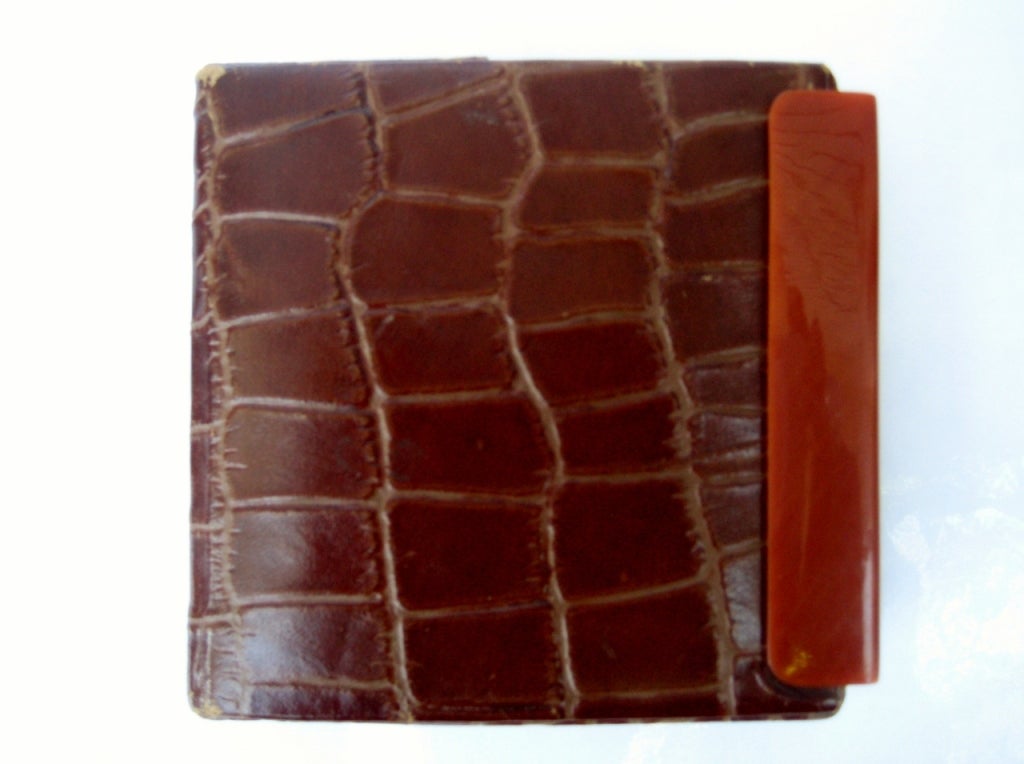 An exceptional design...this compact reveals a pouch pocket and inner Bakelite mirror slide.