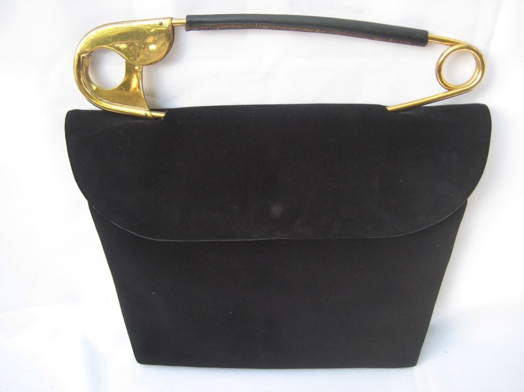 Found in all Vintage Handbag Collectors Handbooks...this artistically whimsical handbag features an exaggerated and functioning brass safety pin handle by the American made company Koret.  This fine suede bag measures 12