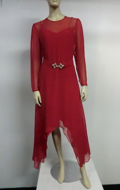 A 70s Adolfo vivid red silk gown in 2 pieces:  Underdress has unique butterfly hem and rhinestone straps.  Outer silk chiffon layer echoes the same butterfly hem and features sheer sleeves and décolletage.  Comes with original rhinestone buckle belt.