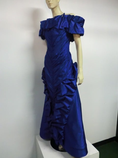 A fantastic statement piece!  An Arnold Scaasi royal blue silk taffeta ruffled off-the-shoulder ball gown.  Fully lined and boned with underskirt--both being edged at hem with wide horsehair braid for body.   Approx. size 4