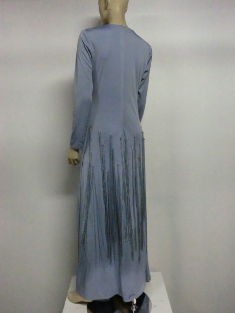 A gorgeous jersey 70s gown in cornflower blue with deep V neckline and scattered long rayon fringe knotted into the skirt.  So chic!  Size 6