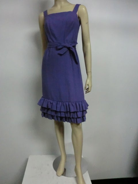 A fantastic little 1950s purple wool structured and boned cocktail dress from Paul Whitney.  Bodice is defined with simple lines, fully lined and boned underneath and bias cut wool on top to mold perfectly to the body.  The three tiers of ruffles at