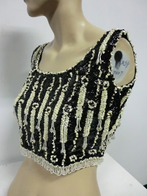 A great little 60s beaded and sequined cropped wool tank from Jo-Ro Imports.  Elaborate beading and sequining includes dangles and a loop fringe at bottom.  Vintage US size 14 is approx. a modern size 6.
