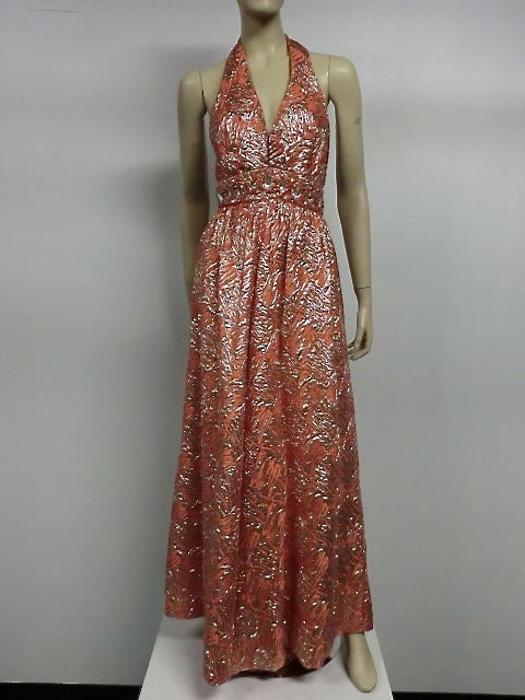 A fantastic 60s coral and silver lamé matelassé halter jumpsuit, with jeweled cummerbund waist and wide flared legs. Fully lined.