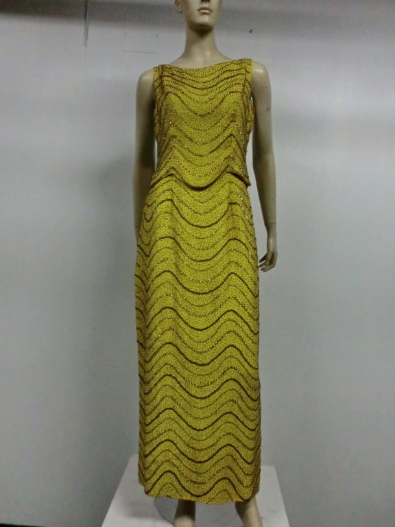 A beautiful 60s two-piece column gown of chartreuse silk crepe, completely beaded in a wave design.  Entirely silk lined and weighted.  Size 6-8.