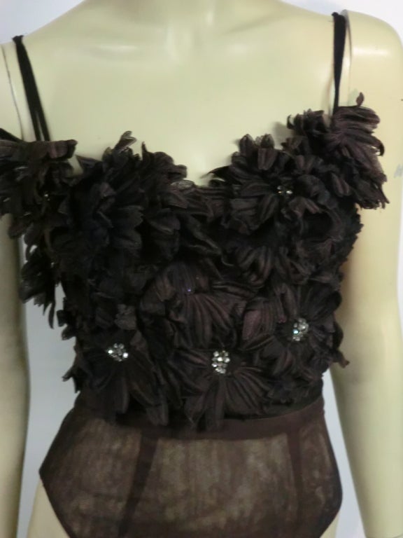 A fabulous element for a big night out!  A 1940s custom-made, for the legendary Ginger Rogers, bustier with attached garter belt covered entirely in chocolate brown heavy silk lace flowers with rhinestone cluster centers. Metal garters.