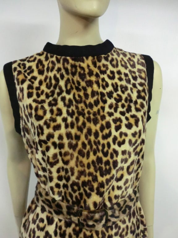 A simple, chic 60s faux leopard fur sleeveless shift dress with black piped neck and armholes.  Matching optional belt included.