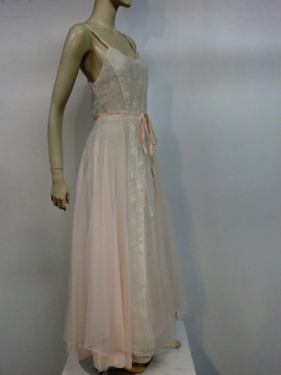 A gorgeous Schiaparelli nightgown/negligee in peach chiffon and ecru lace with a velvet ribbon sash.  Nylon.  Marked size 36.