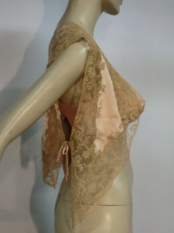 French-made 1930s brassiere by Andree Lefaucheur and silk lace and satin bed jacket, both in peach silk satin and lace.  Bed jacket has delicate silk piping ties on each side.  32 C.