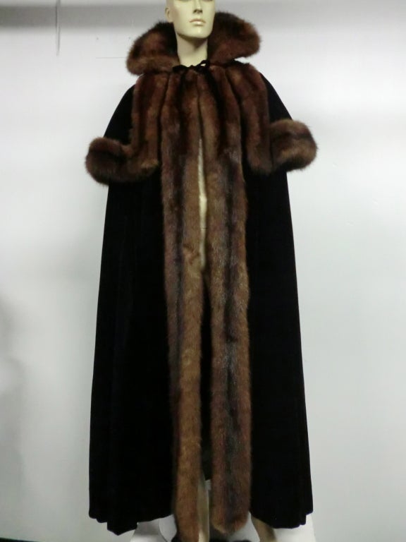 An incredible 1950s Mainbocher extravagant evening cape in black silk velvet and lush sable trim.  Long under layer and additional short trimmed capelet make for a regal appearance.  Very full sweep silhouette. Tag  has come off since receiving, but