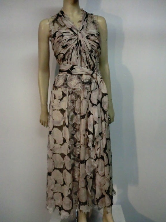 A beautiful, delicate Chanel dress by Karl Lagerfeld in floral printed silk chiffon and lace.  Longer length skirt with sash tie, gathered knotted chiffon bodice and trimmed in delicate silk.  Size 38.
