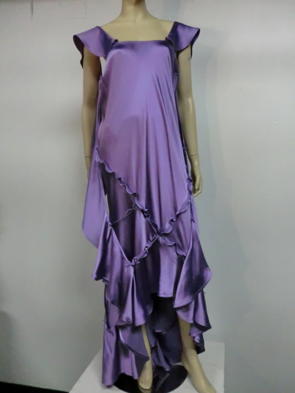 A dramatic Yves Saint Laurent lavender silk satin gown designed by Tom Ford with slashed and ruffled panels attached at intervals to float and flutter.  Back zipper.  Size 42.