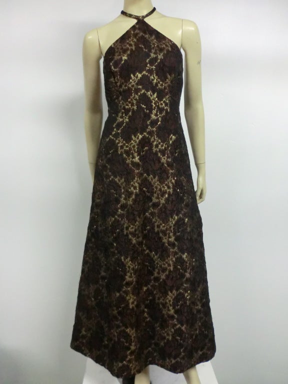 A great, petite size, 60s silk lamé brocade halter dress that is A-line shaped to the floor or ankle. Brown and gold floral brocade.  Lined. Size 2-4 petite