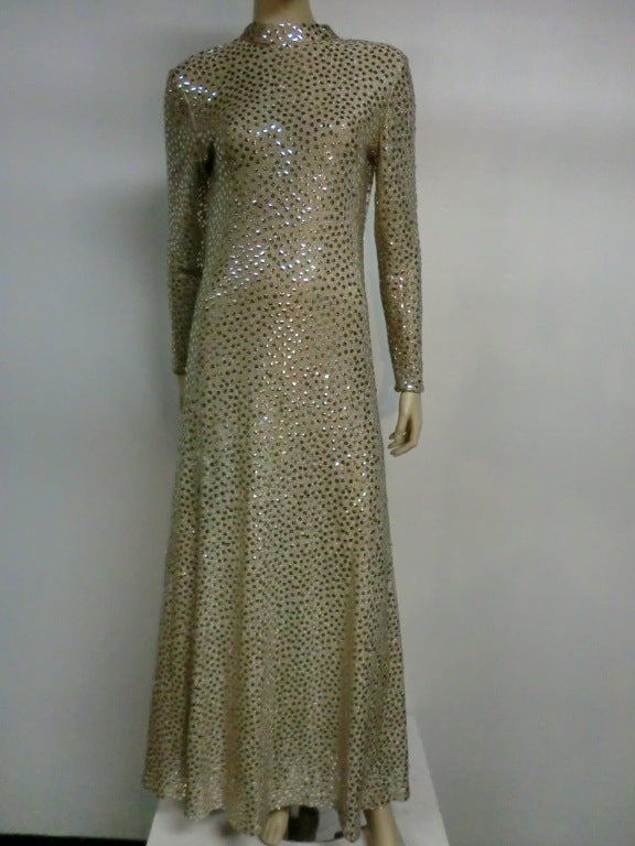 A fabulous 70s era Mollie Parnis Boutique lurex knit and sequin maxi gown with deep 