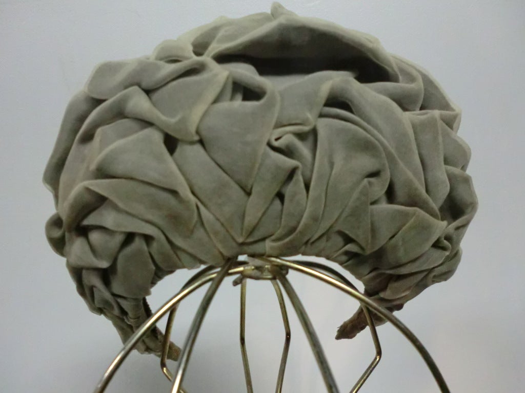 A gorgeous authentic Christian Dior couture chapeaux in gray silk chiffon.  Hair comb attached inside for secure wear.  Worn at the back of the head to stand up like a crown.