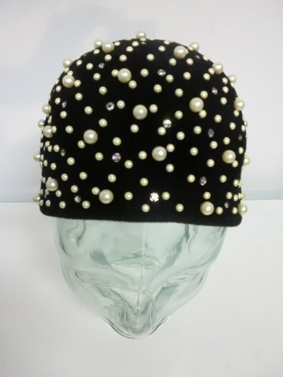 A wonderful 1960s bubble cloche shaped black fur felt hat with rhinestone and faux pearl embellishment.  Size M.