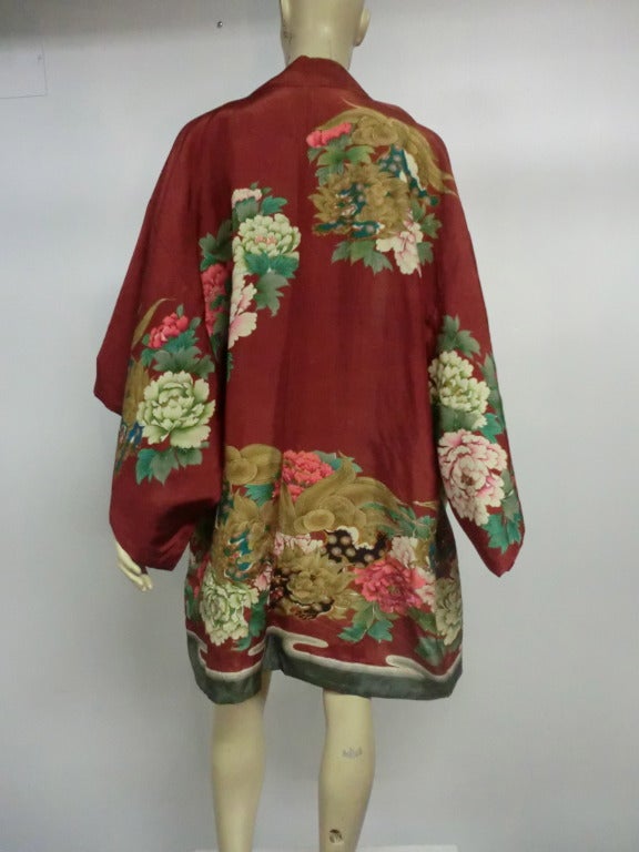 A gorgeous 1940s silk, knee-length kimono with peony an water print and metallic embroidered Foo dog patterns on a rust color background.