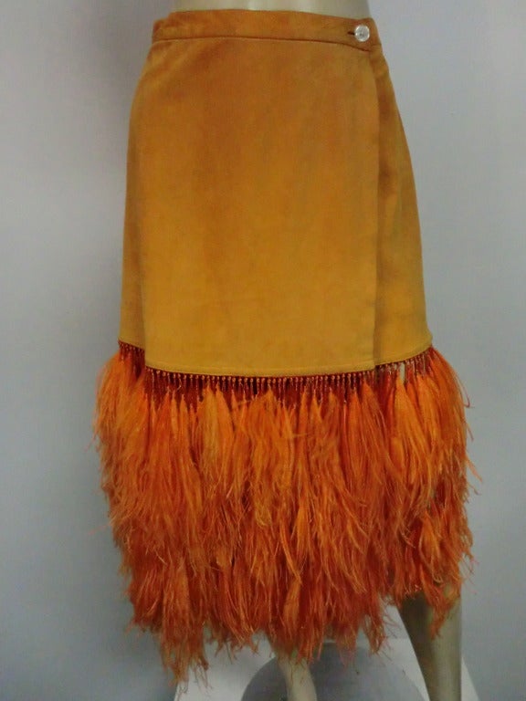 A fabulous orange colored suede wrap skirt from Anna Trzebinski  (Circa 90s?) fully lined with incredible, extravagant heavy fringe of rayon cord and beaded ostrich feather fringe that flows like mad!