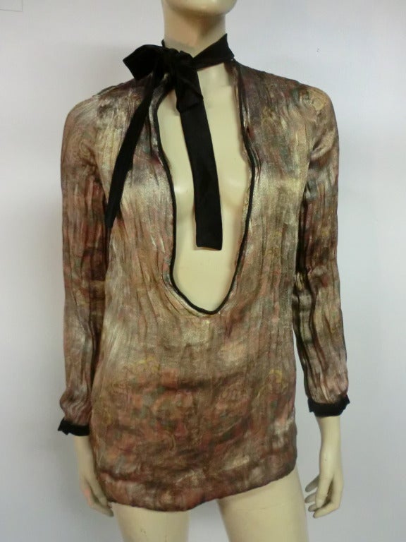 A gorgeous 1920's silk lamé tunic top with the outside being a subtle metallic and the inside vivid colored pattern.  Large 