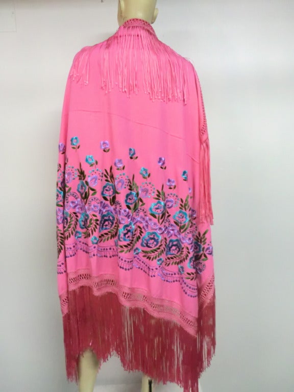 A gorgeous fuschia rayon embroidered shawl with long rayon tied fringe.