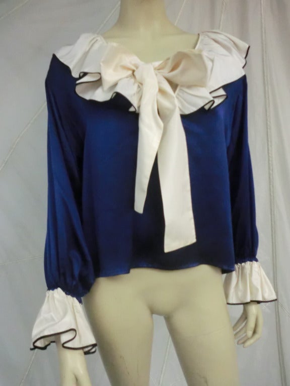A fabulous royal blue silk blouse with balloon sleeves and ivory ruffles (edged with color) at neckline and sleeve cuffs.