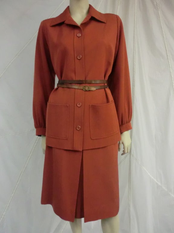 A simple, classic 1970's Yves Saint Laurent wool gabardine, rust color skirt suit, with (not YSL) belt included.  Front buttons, deep pockets and deep pleated skirt.