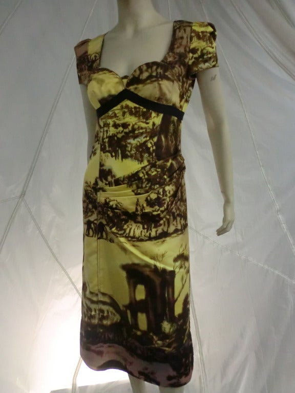 A modern Prada dress with 40s inspired styling in the bodice cut, printed all over in brown and yellow 