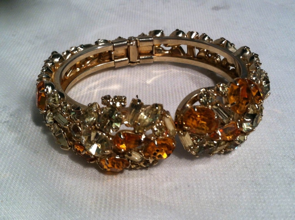 1950s fabulous smokey and topaz color prong-set rhinestones on a spring-hinged cuff bracelet.