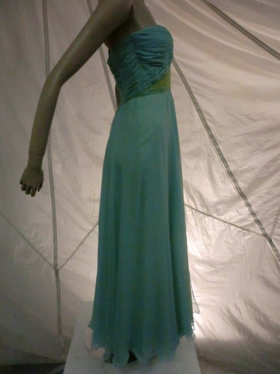 A gorgeous 1960s strapless silk chiffon gown in colors to suit a mermaid!  Turquoise, azure and sea green are blended in beautiful silk chiffon:  layered in the skirt and gathered in the knotted bodice.  Boned bodice, back zip.  Gorgeous!