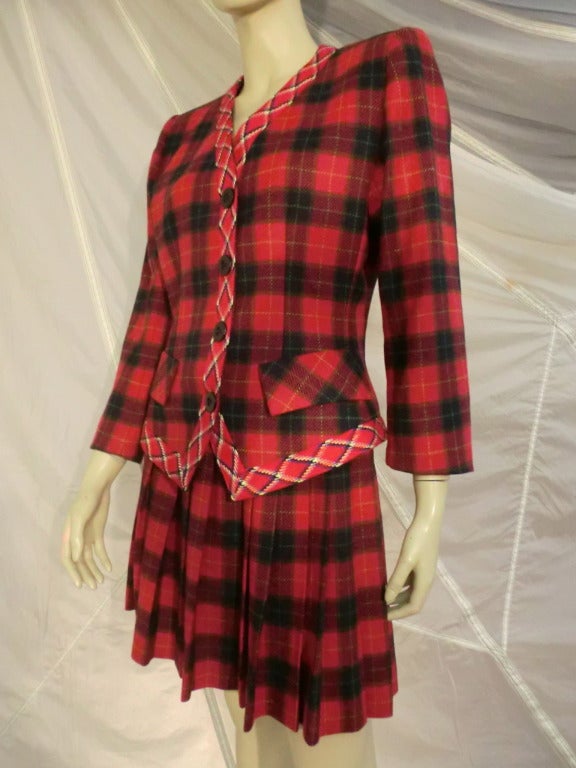 A lovely 1980s Yves Saint Laurent wool and cashmere plaid skirt suit:  sharply pleated knee-length skirt and padded shoulder jacket with contrasting trim around jacket placket, neck and hem.  Lined jacket.