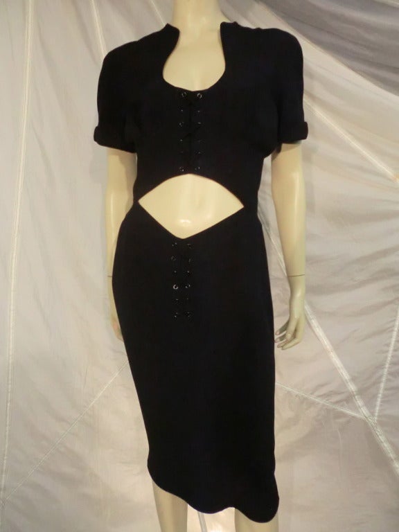 A 1980s Thierry Mugler black cocktail dress with criss-cross eyelet lacing detail and midriff cutout.