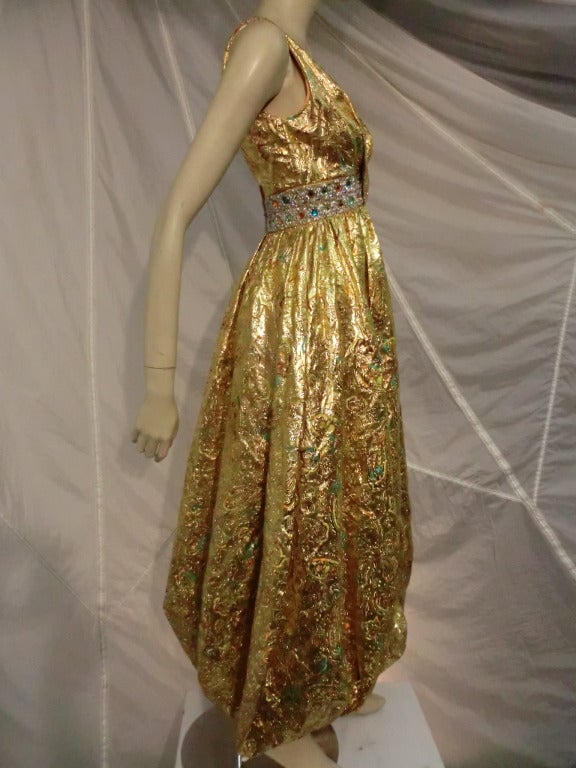 A gorgeous and unusual 1960s metallic brocade jumpsuit with extremely full harem-style gathered bottom legs and jeweled waistband.  A real statement piece! Size 4-6