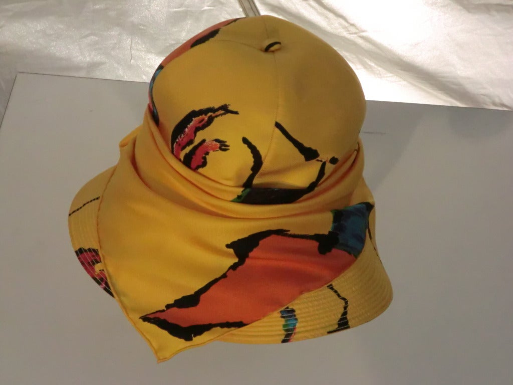 A gorgeous 1970s Adolfo stitched brim hat with large graphic Pop Art style print in marigold, orange, teal and black.  From Saks Fifth Avenue.