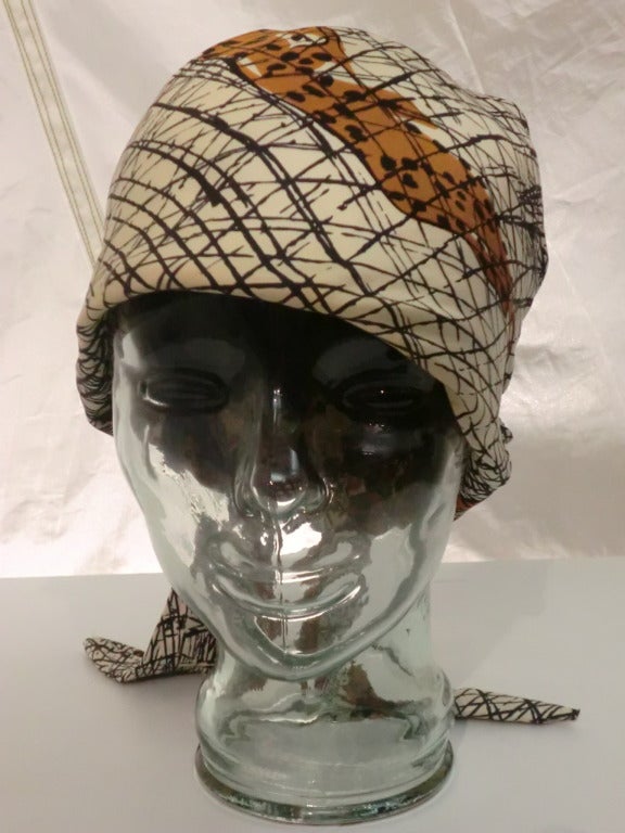 A fabulously chic and casual B.H. Wragge 1960s leopard print silk scarf hat.  Knotted in back and fully constructed.  Medium size.